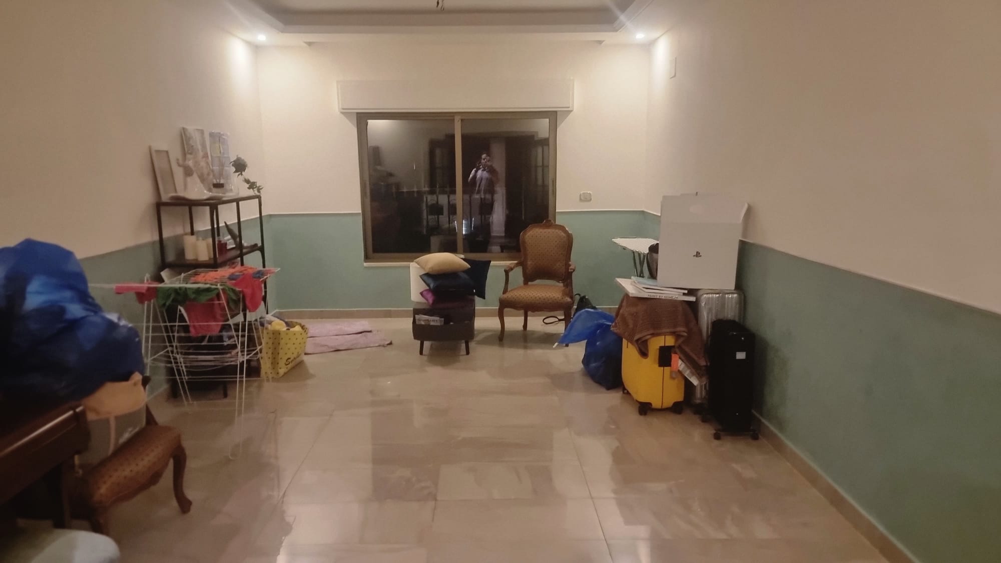 Apartment living room before renovation — old two-tone walls