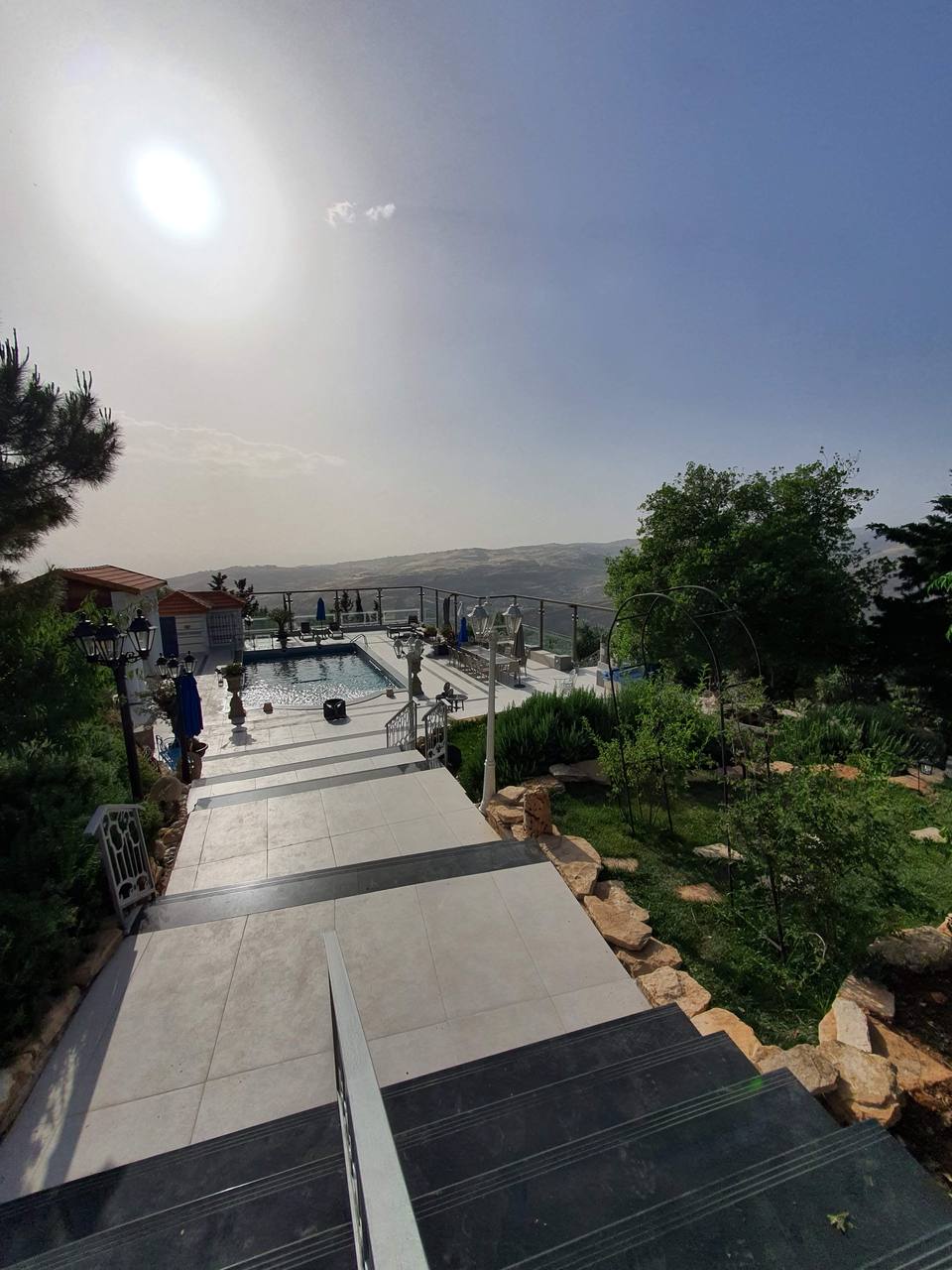 Estate overview — pool terrace with Amman valley views