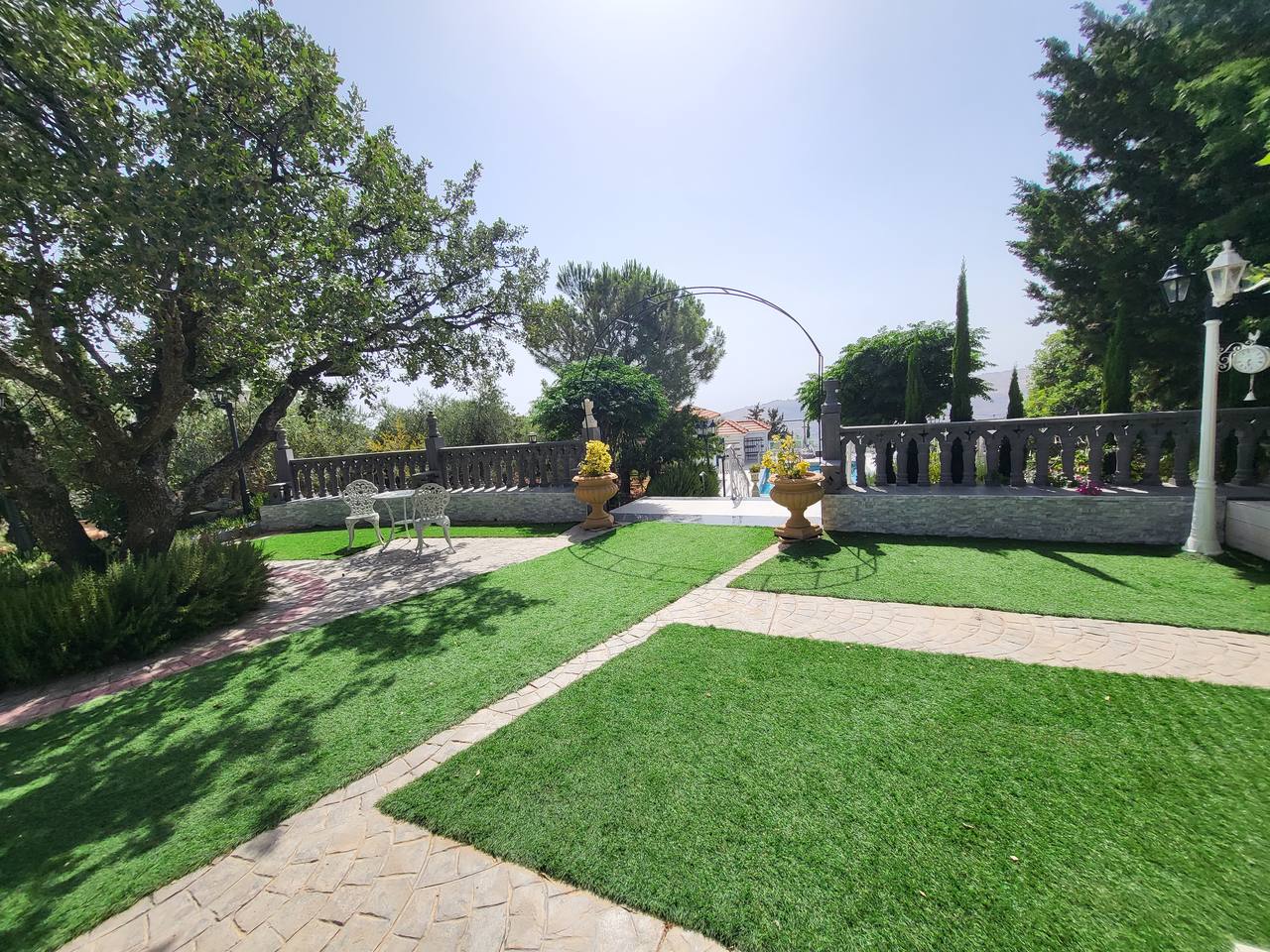 Landscaped garden — artificial lawn, stone path and planters