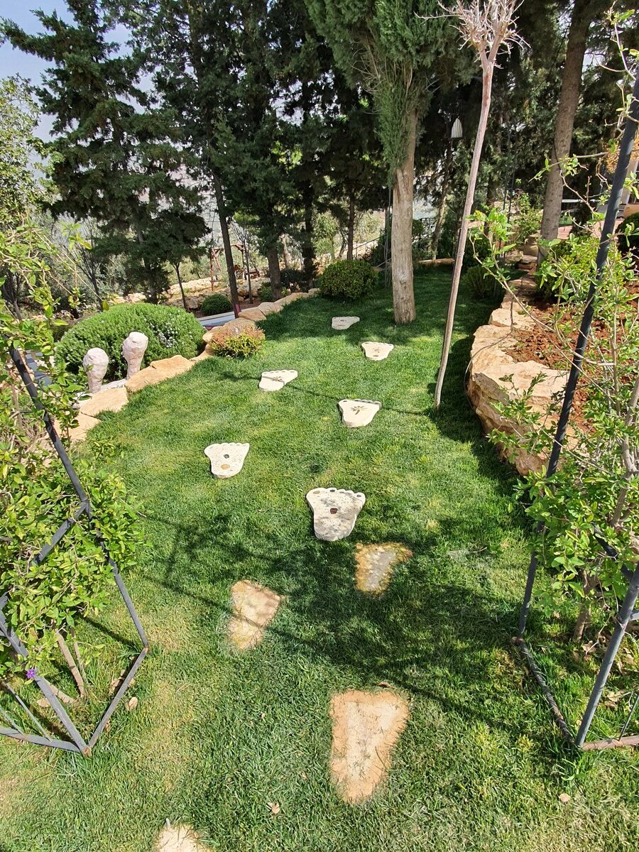 Estate garden delivered — manicured lawn with stepping stones and mature planting