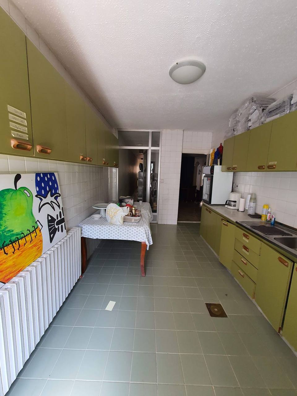 Original kitchen before renovation — dated layout awaiting full fit-out