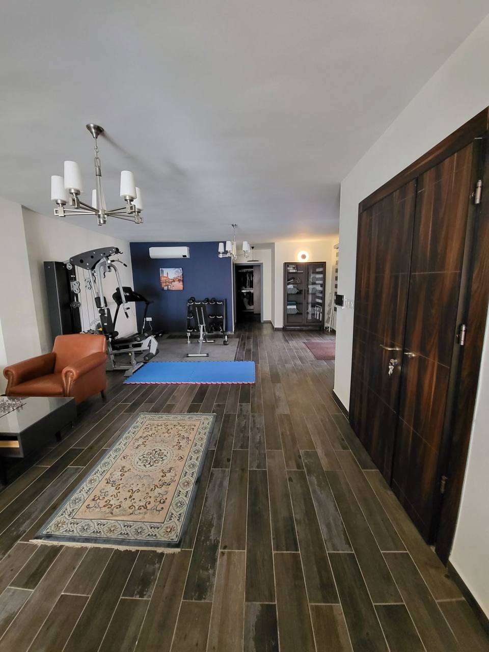 Ground floor completed fit-out — dark wood-effect porcelain flooring and modern joinery