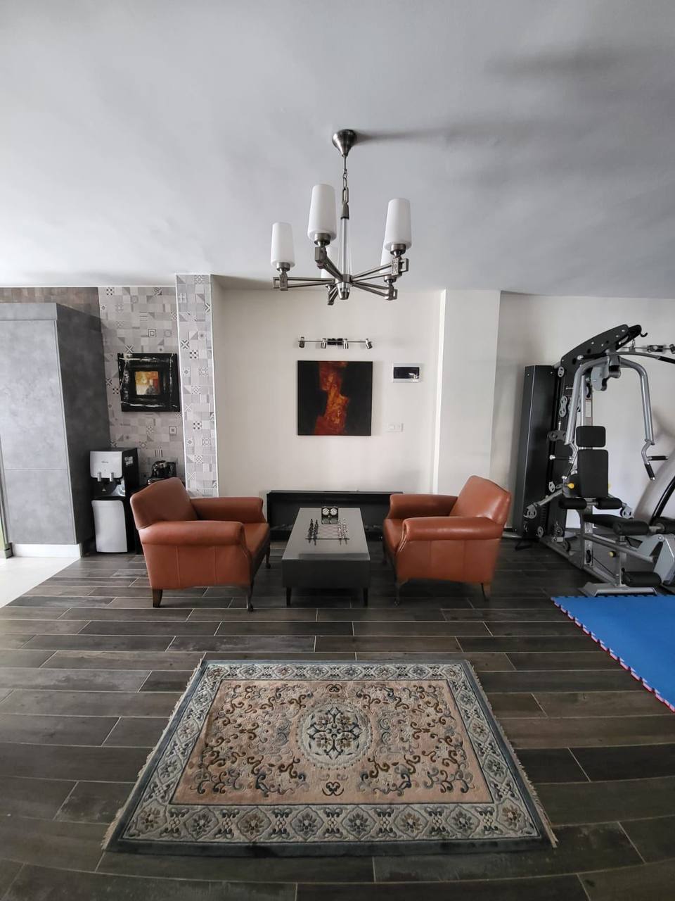 Ground-floor lounge with leather chairs and artwork — interior fit-out