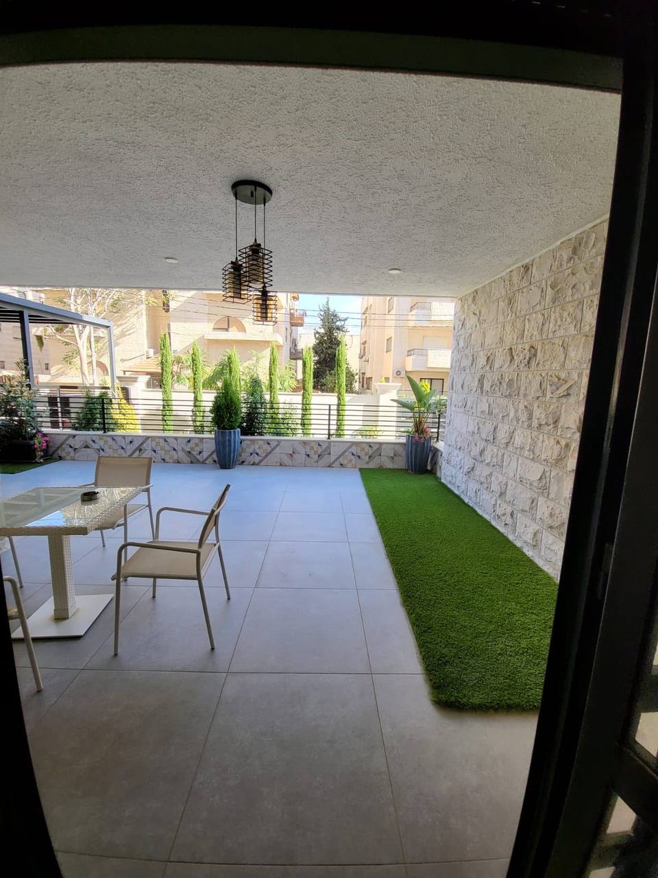 Ground-floor covered terrace with garden outlook — completed