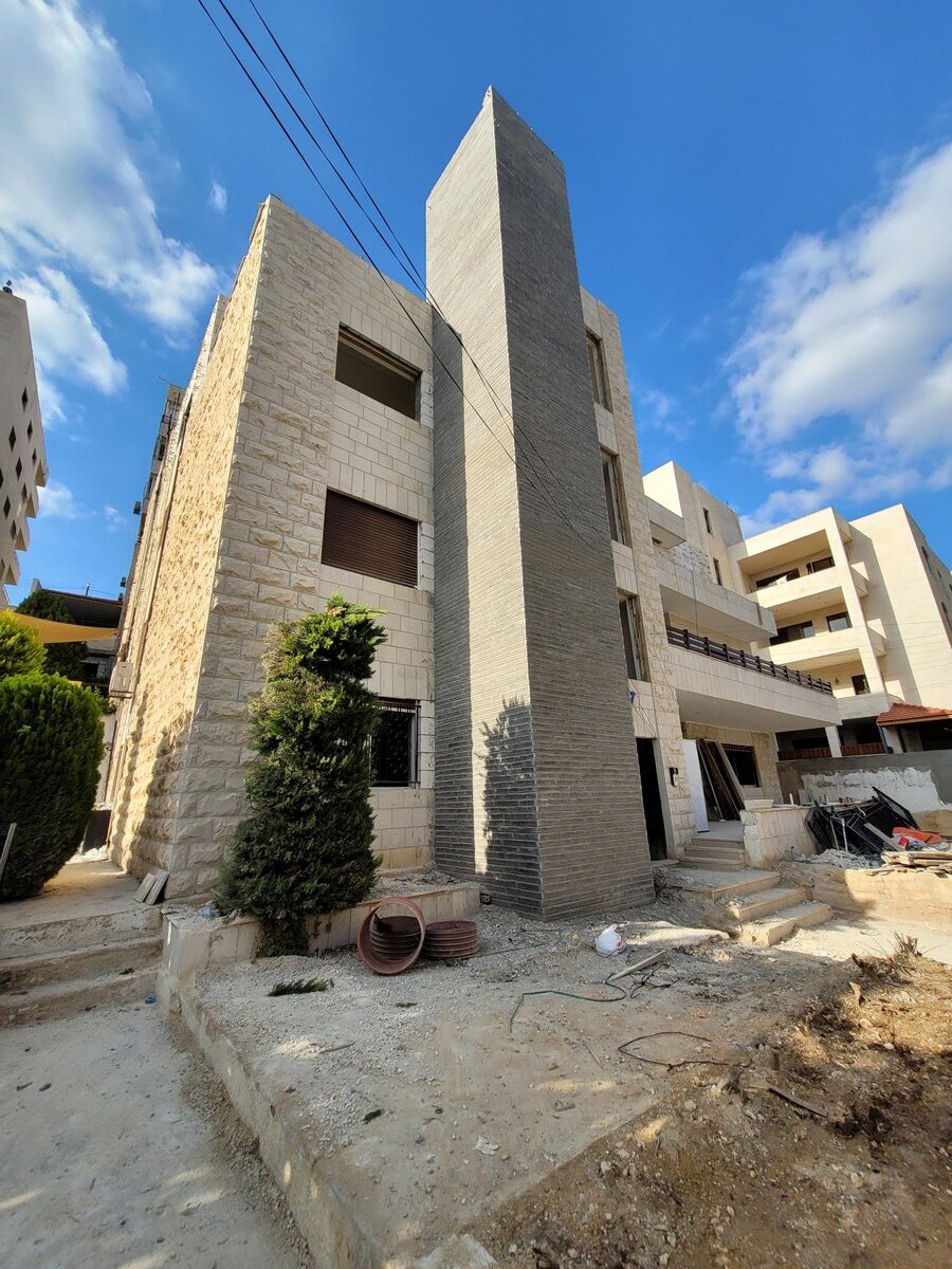 New elevator shaft and facade shell — building exterior during structural works