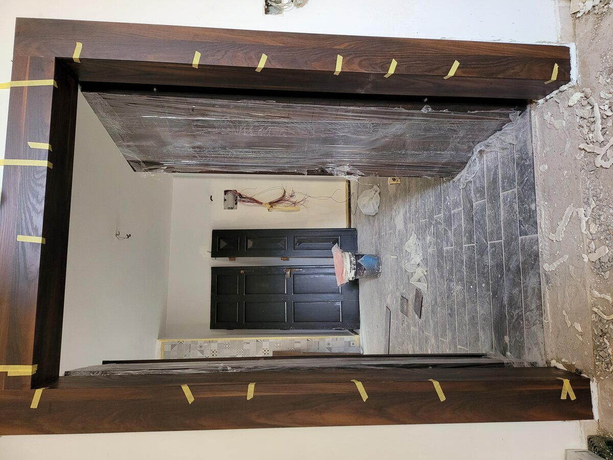 Master bathroom during wet works — shower tray, drain and waterproofing membrane stage
