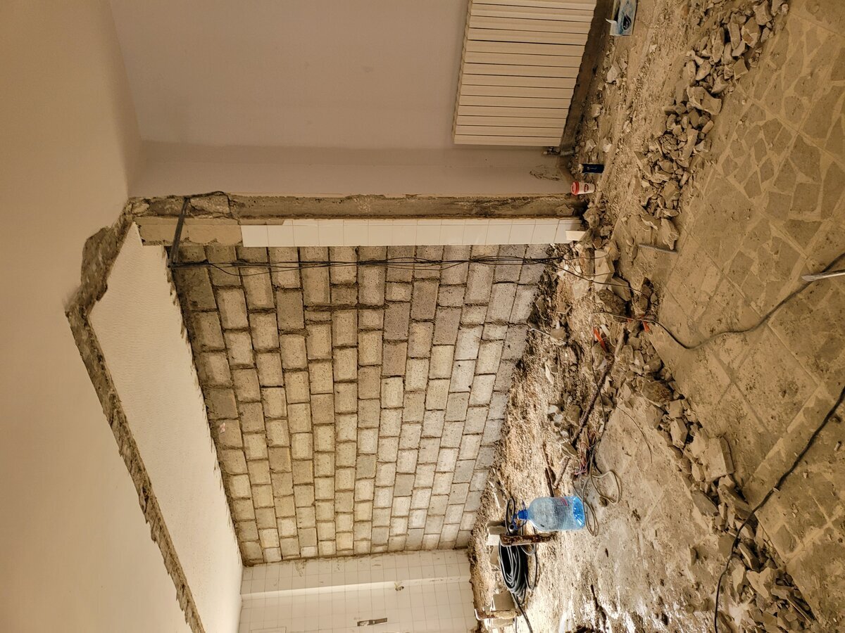 Structural intervention — core drilling and reinforcement tie work at ground-floor slab