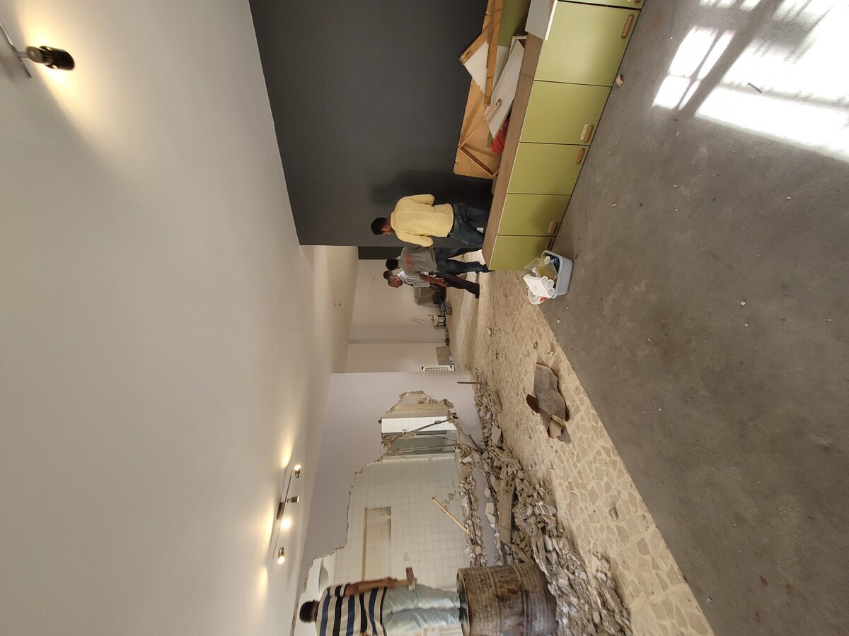 Ground floor during controlled demolition — wall removal to create open plan, supervised by structural engineer