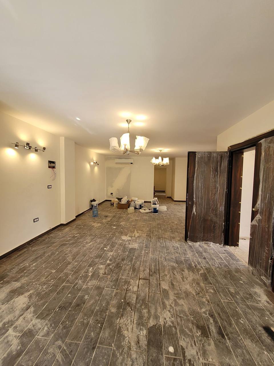 Interior during finishing phase — flooring laid, decoration and joinery in progress